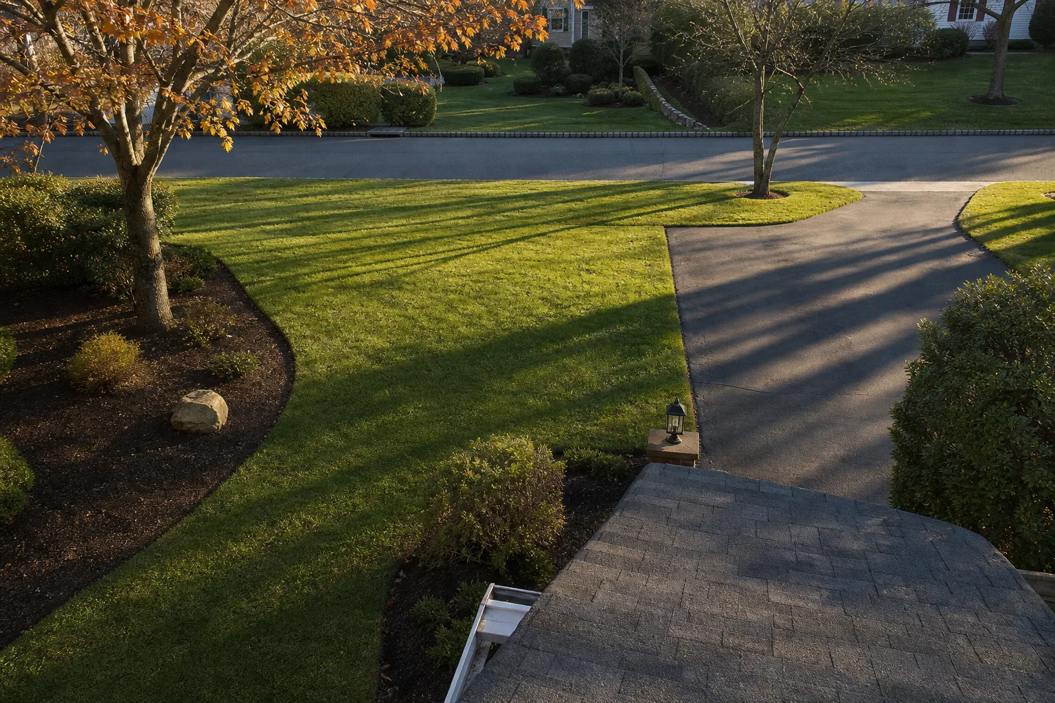Overhead view of a residential yard during fall cleanup, leaves staged for removal